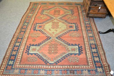 Lot 1071 - Kazak rug, Central Caucasus, the madder field with three linked latch hook medallions enclosed...