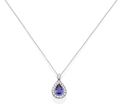 Lot 345 - A Tanzanite and Diamond Pendant on Chain, a pear cut tanzanite within a border of round...