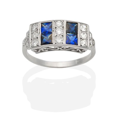 Lot 346 - A Sapphire and Diamond Ring, a rectangular top set with square cut sapphires spaced by groups...