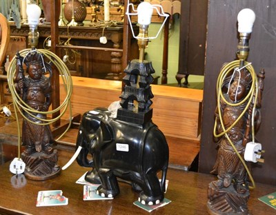 Lot 1246 - # A pair of Japanese carved hardwood figures/table lamps and an early 20th century ebony...