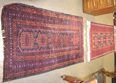 Lot 1250 - Balouch rug, Persian/Afghan Frontier, the indigo field with a colum of serrated devices enclosed by