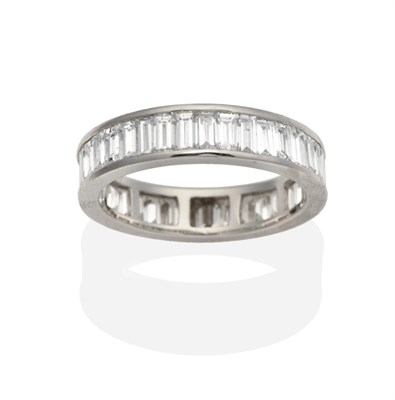 Lot 357 - A Platinum Diamond Eternity Ring, of channel set baguette cut diamonds, total estimated diamond...