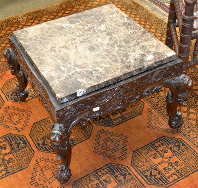 Lot 1264 - # A Burmese carved hardwood coffee table with later marble top (altered from a chair)