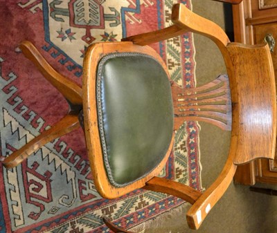 Lot 1268 - Oak swivel chair with leather seat