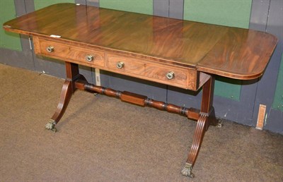 Lot 1339 - George IV mahogany sofa table raised on brass claw feet