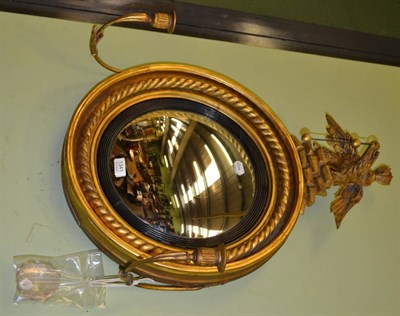 Lot 1341 - Regency gilt convex mirror with ebonised slip