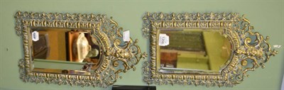 Lot 1356 - # A pair of 19th century brass bevelled glass repousse decorated mirrors