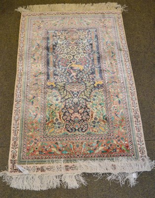 Lot 1364 - A good Chinese silk prayer rug of Ghom design, The ivory field centred by an urn issuing...