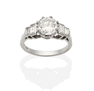 Lot 372 - A Platinum Solitaire Diamond Ring, a brilliant cut diamond in a claw setting, to shoulders...