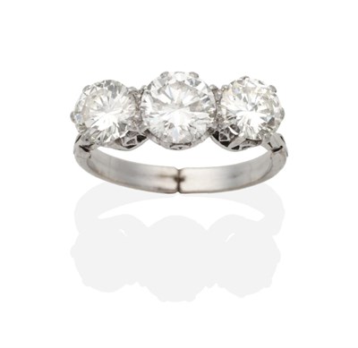 Lot 377 - A Three Stone Diamond Ring, round brilliant cut diamonds in claw settings, to knife edge...