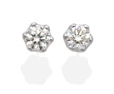 Lot 379 - A Pair of 18 Carat White Gold Solitaire Diamond Earrings, a round brilliant cut diamond in a...