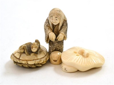 Lot 147 - Three Japanese carved ivory netsuke circa 1900; one as an old lady with a skull, signed, another as