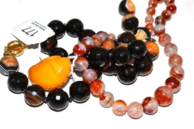 Lot 177 - A sardonyx and agate necklace, a moss agate necklace and an amber brooch (3)