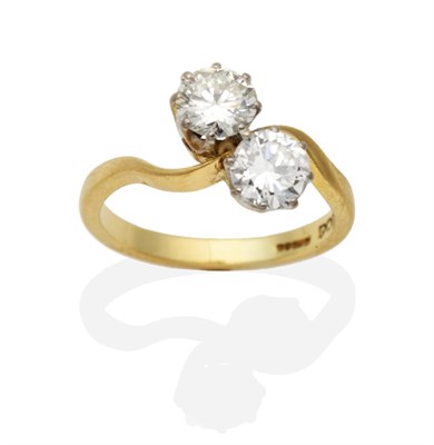 Lot 396 - An 18 Carat Gold Two Stone Diamond Twist Ring, round brilliant cut diamonds in claw settings,...