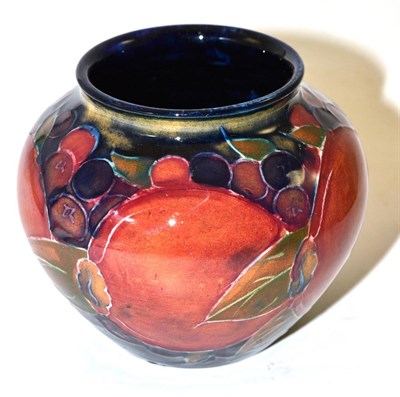 Lot 249 - A William Moorcroft Pomegranate pattern vase, on a blue ground, impressed factory marks and...