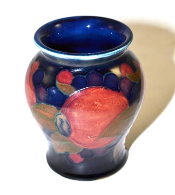 Lot 254 - A William Moorcroft Pomegranate pattern vase, on a blue ground, impressed factory marks and...