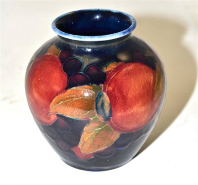 Lot 255 - A William Moorcroft Pomegranate pattern vase, on a blue ground, impressed factory marks and...