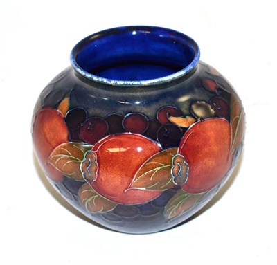 Lot 262 - A William Moorcroft Pomegranate pattern vase, on a blue ground, impressed factory marks, blue...