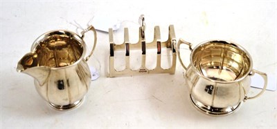 Lot 265 - Silver milk jug and sugar bowl and a silver toast rack