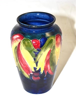 Lot 285 - A William Moorcroft Leaf and Grape pattern vase, on a blue ground, impressed factory marks,...