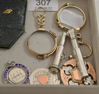 Lot 307 - Two lorgnettes, two silver cigar piercers and three fobs and medallions