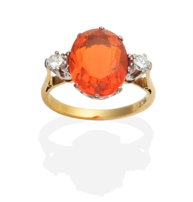 Lot 407 - A Fire Opal and Diamond Three Stone Ring, an oval cut fire opal between two round cut diamonds...