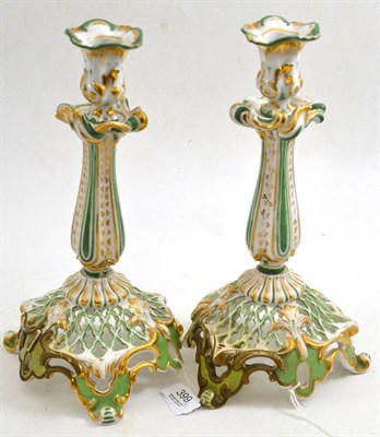 Lot 399 - Pair of porcelain green and gilt candlesticks (restored)