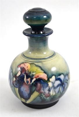 Lot 424 - A Walter Moorcroft Orchid and Spring Flowers pattern globular scent bottle and stopper, with...