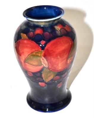 Lot 425 - A William Moorcroft Pomegranate pattern baluster vase, on a blue ground, impressed factory...