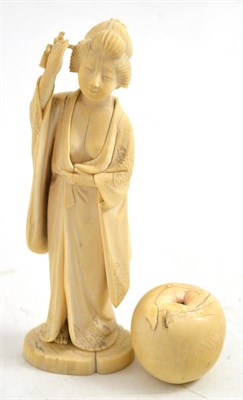 Lot 429 - A late 19th century Japanese ivory okimono of a court figure wearing a loose robe and revealing her