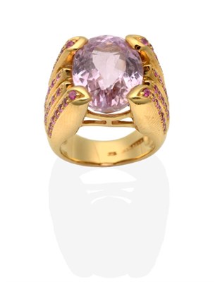 Lot 424 - A Kunzite and Ruby Ring, an oval cut kunzite in a claw setting, to forked shoulders inset with rows