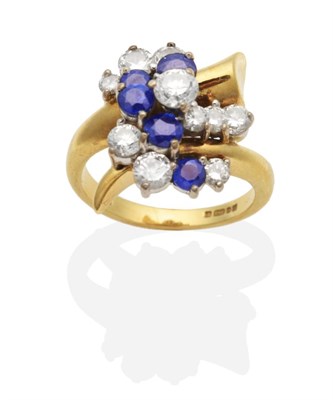 Lot 426 - An 18 Carat Gold Diamond and Sapphire Ring, groups of vari-sized round brilliant cut diamonds...