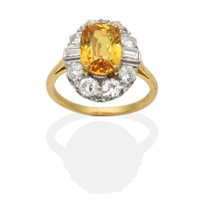 Lot 432 - A Yellow Sapphire and Diamond Cluster Ring, an oval cut yellow sapphire within a border of...