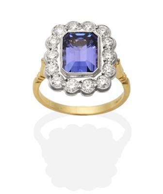 Lot 433 - A Tanzanite and Diamond Cluster Ring, an octagonal cut tanzanite within a border of round brilliant