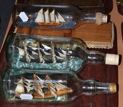 Lot 549 - Ships In Bottles: three three-masted sailing vessels including a coastal Schooner (3)