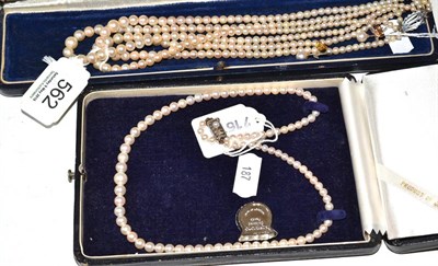 Lot 562 - Two pearl necklaces and a pair of matching ear studs