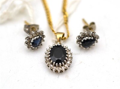 Lot 563 - A 9ct gold sapphire and diamond pendant with matching chain and similar pair of ear studs