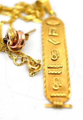 Lot 582 - A pendant charm on chain and a single knot earring