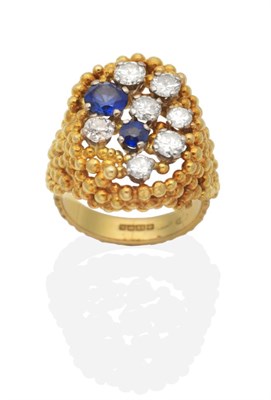 Lot 444 - An 18 Carat Gold Diamond and Sapphire Ring, round brilliant cut diamonds and two round cut...