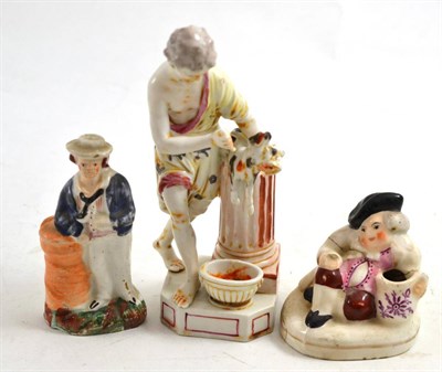 Lot 625 - Continental figure slaughtering a goat, no. 142, a Staffordshire figure and a Toby inkwell (3)