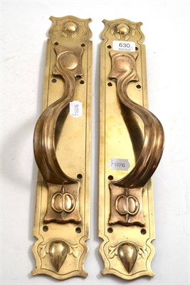 Lot 630 - A pair of Art Nouveau brass door plates and handles