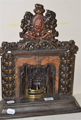 Lot 677 - Cast iron miniature fire place