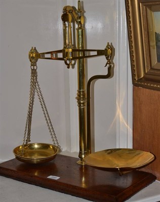 Lot 699 - A brass beam scale on mahogany base from Gawity and Hoggarth snuff makers