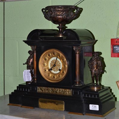 Lot 726 - A black slate striking mantel clock mounted with a bronze copy of the Warwick vase, side bronze...