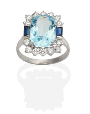 Lot 463 - An 18 Carat White Gold Aquamarine, Sapphire and Diamond Cluster Ring, an oval cut aquamarine in...