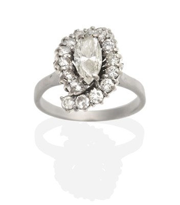 Lot 468 - A Diamond Cluster Ring, a marquise cut diamond within an undulating border of round brilliant...