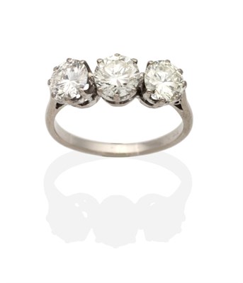 Lot 482 - A Three Stone Diamond Ring, graduated round brilliant cut diamonds in claw settings, to knife...