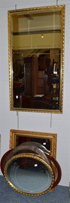 Lot 1078 - An Arts & Crafts style embossed circular wall mirror and four decorative modern mirrors