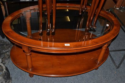 Lot 1097 - A reproduction yewwood oval glass coffee table