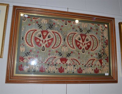 Lot 1149 - Possibly late 19th century Turkish style floral applique on blue silk ground, in a modern frame